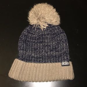Navy and brown winter hat with top.